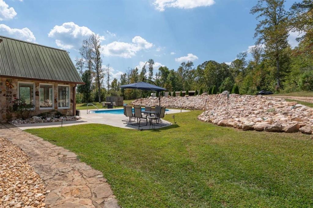 6058 Mt Zion Road Waco, GA 30182 - Photo 57 of 72 a view of a house with swimming pool and sitting area