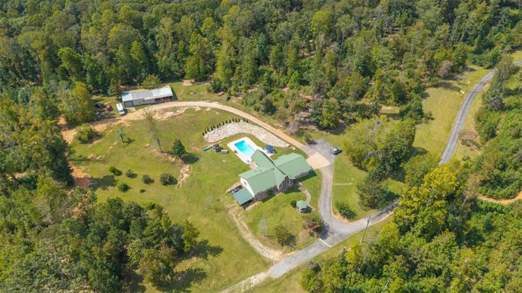 6058 Mt Zion Road Waco, GA 30182 - Photo 7 of 72 a view of a swimming pool with a yard