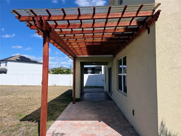 a view of a porch with a table and chairs