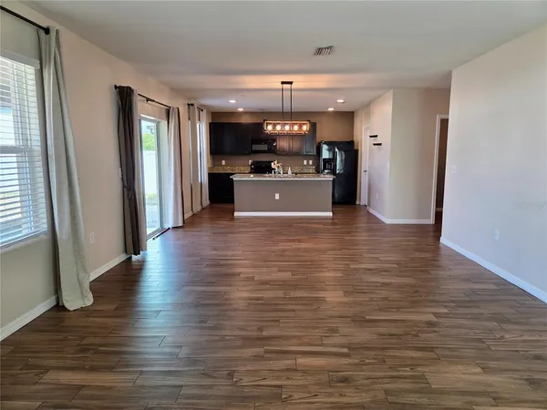 a view of a kitchen cabinets and wooden floor