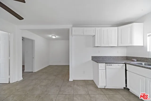 a kitchen with white cabinets