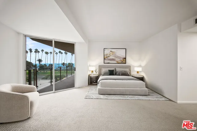 a spacious bedroom with a bed and glass door