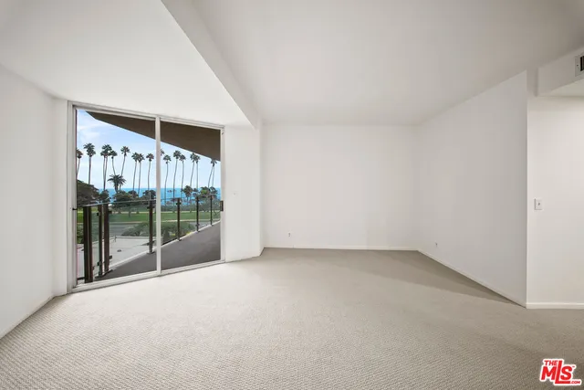 a view of a room with sliding door and wooden floor