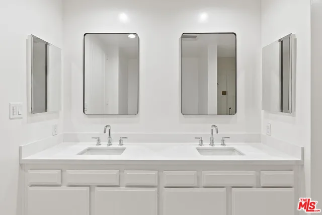 a bathroom with double vanity sinks double vanity and a mirror