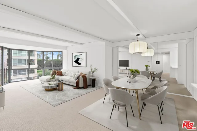 a dining room with furniture and a large window