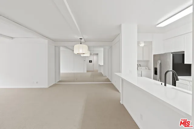 a view of a kitchen with a sink and a large window