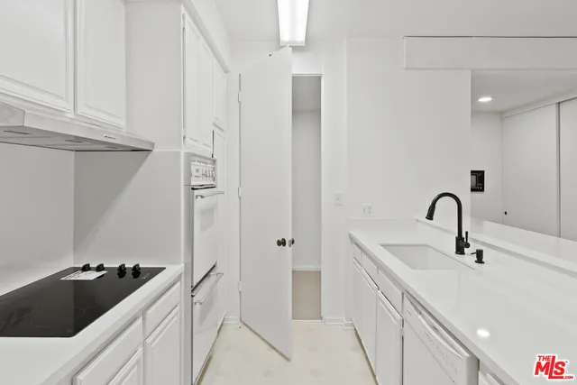 a kitchen with a sink and refrigerator