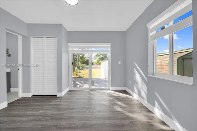 a kitchen with kitchen island a sink window and cabinets