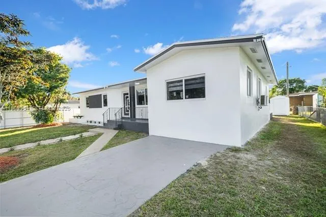an empty room with wooden floor and window