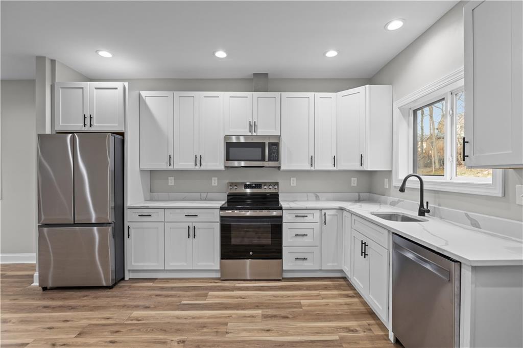 817 Eldora Place Pittsburgh, PA 15210 - Photo 11 of 29 a kitchen with a refrigerator and a sink