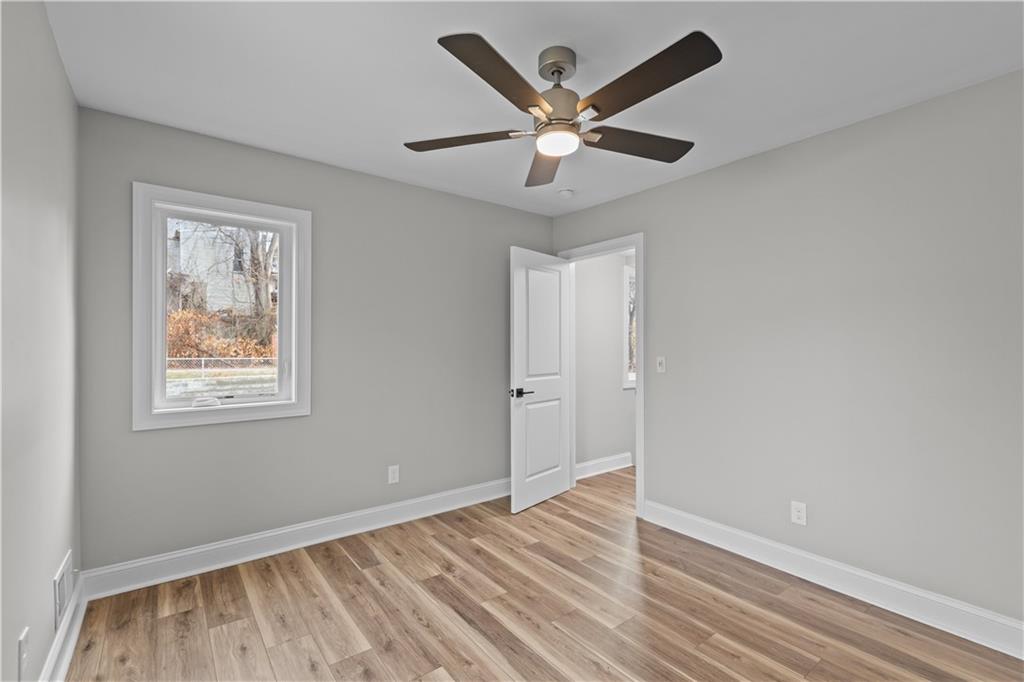 817 Eldora Place Pittsburgh, PA 15210 - Photo 15 of 29 a view of an empty room with wooden floor and a ceiling fan