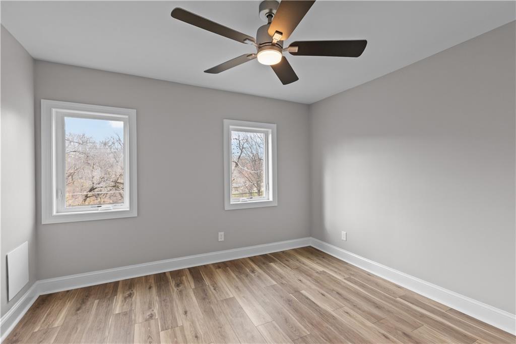 817 Eldora Place Pittsburgh, PA 15210 - Photo 16 of 29 wooden floor in an empty room with a window
