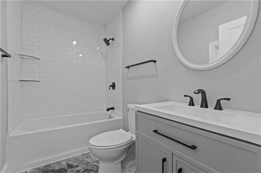 817 Eldora Place Pittsburgh, PA 15210 - Photo 19 of 29 a bathroom with a sink a toilet and a mirror