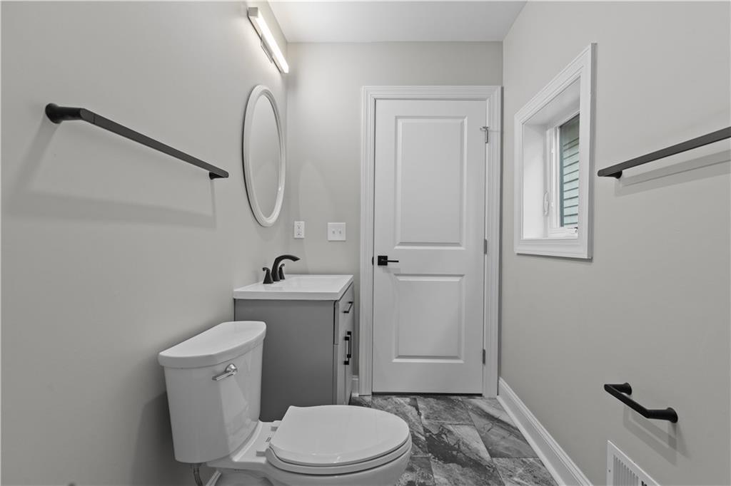 817 Eldora Place Pittsburgh, PA 15210 - Photo 20 of 29 a white toilet sitting next to a bathroom sink