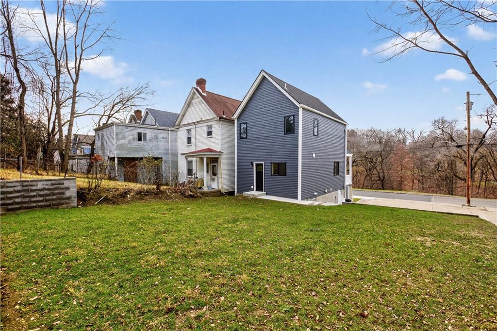 817 Eldora Place Pittsburgh, PA 15210 - Photo 29 of 29 a front view of house with yard and trees in the background