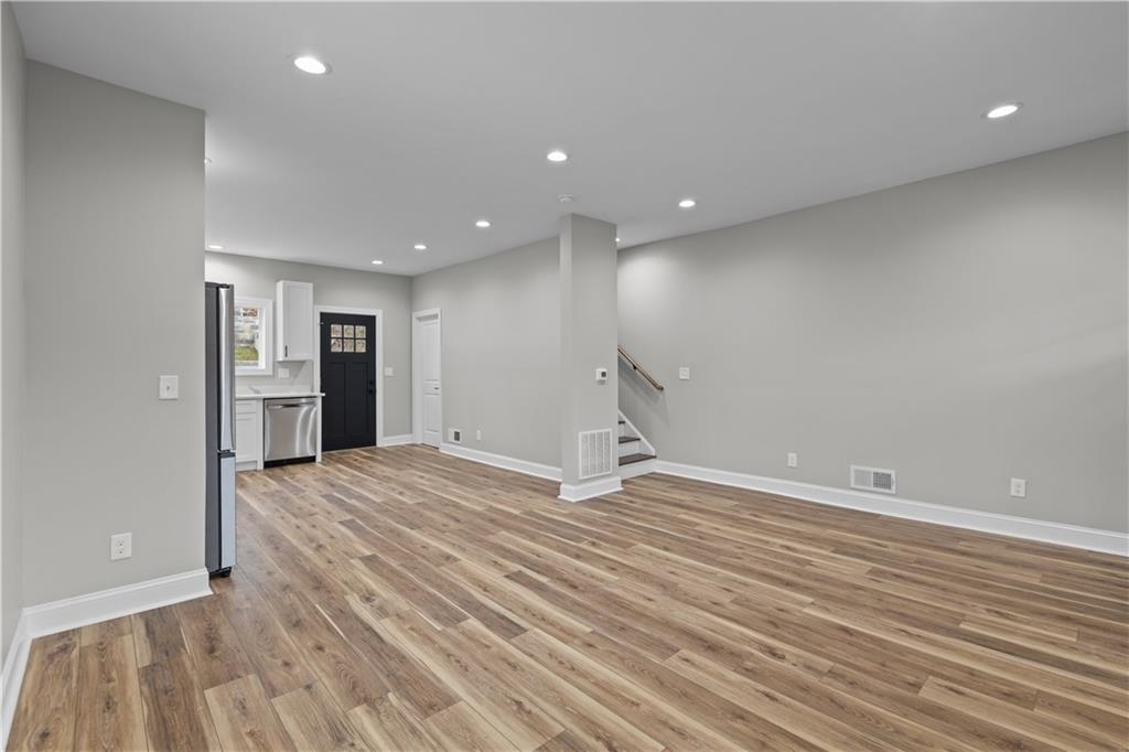 817 Eldora Place Pittsburgh, PA 15210 - Photo 5 of 29 a view of an empty room with wooden floor and kitchen
