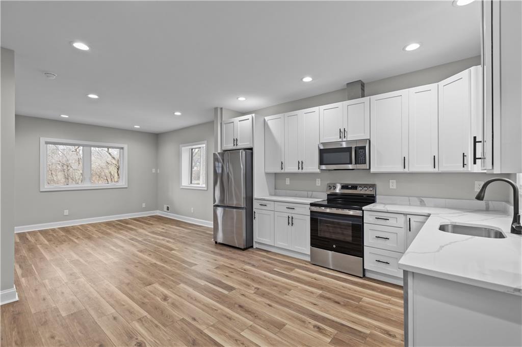 817 Eldora Place Pittsburgh, PA 15210 - Photo 8 of 29 a kitchen with stainless steel appliances a refrigerator stove microwave and sink