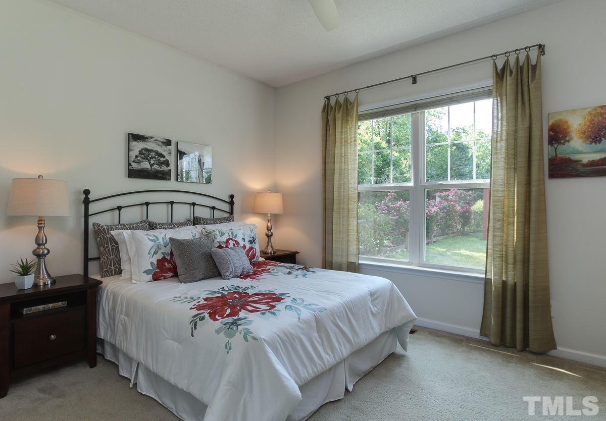 558 East Martin Street Raleigh, NC 27601 - Photo 12 of 24 a bedroom with a large bed and a window