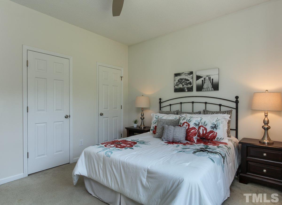 558 East Martin Street Raleigh, NC 27601 - Photo 13 of 24 a bedroom with a bed and a lamp on dresser