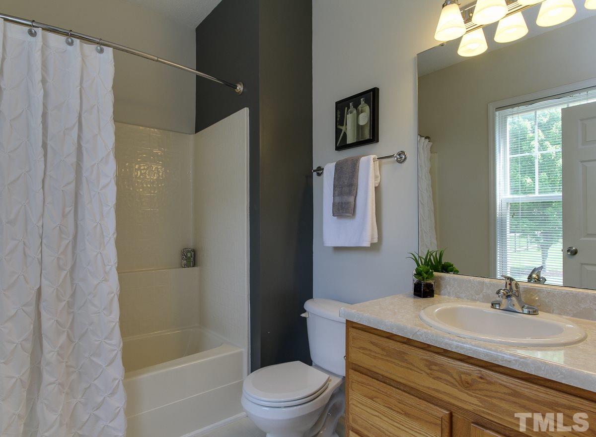 558 East Martin Street Raleigh, NC 27601 - Photo 15 of 24 a bathroom with a sink toilet a mirror and shower