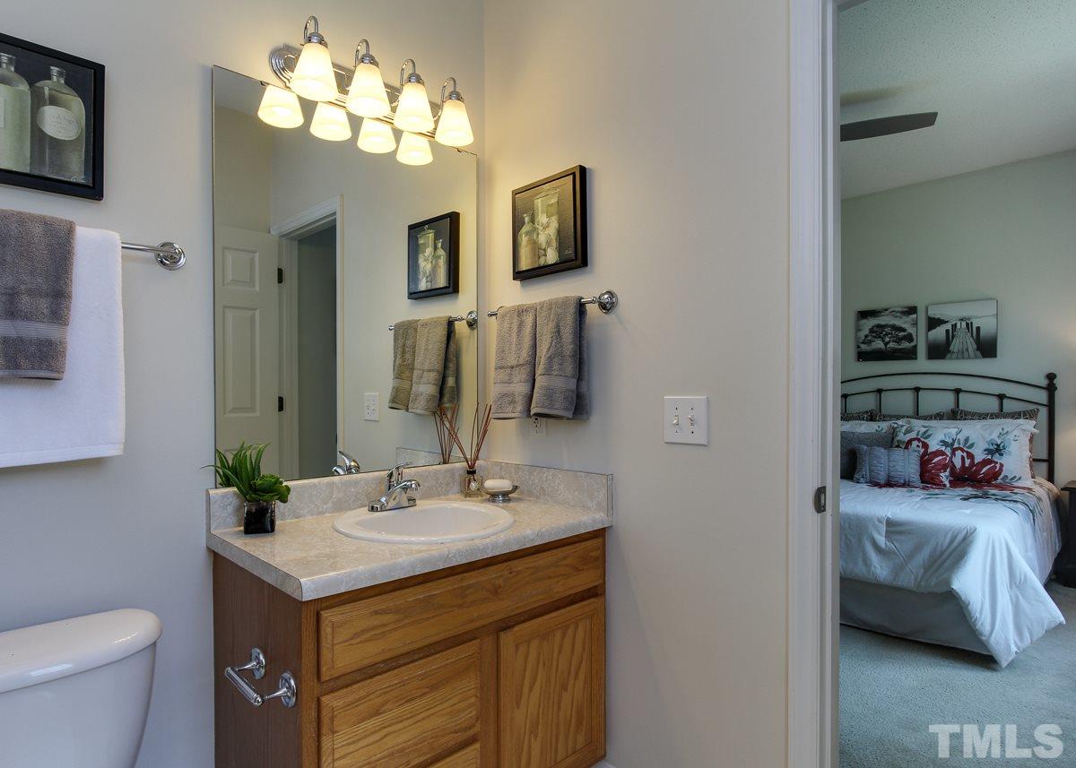 558 East Martin Street Raleigh, NC 27601 - Photo 16 of 24 a bathroom with a sink a toilet and a mirror