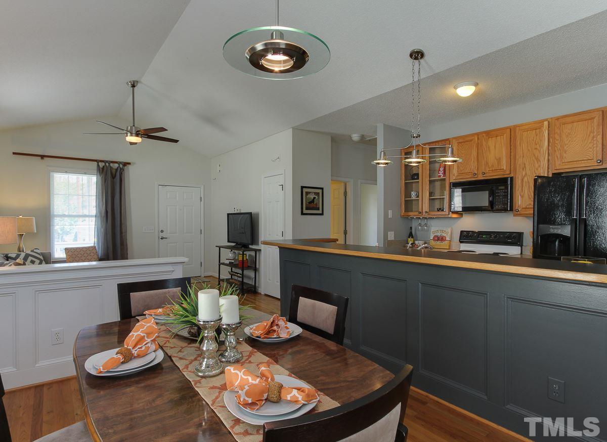 558 East Martin Street Raleigh, NC 27601 - Photo 7 of 24 a kitchen with a table chairs stove and microwave