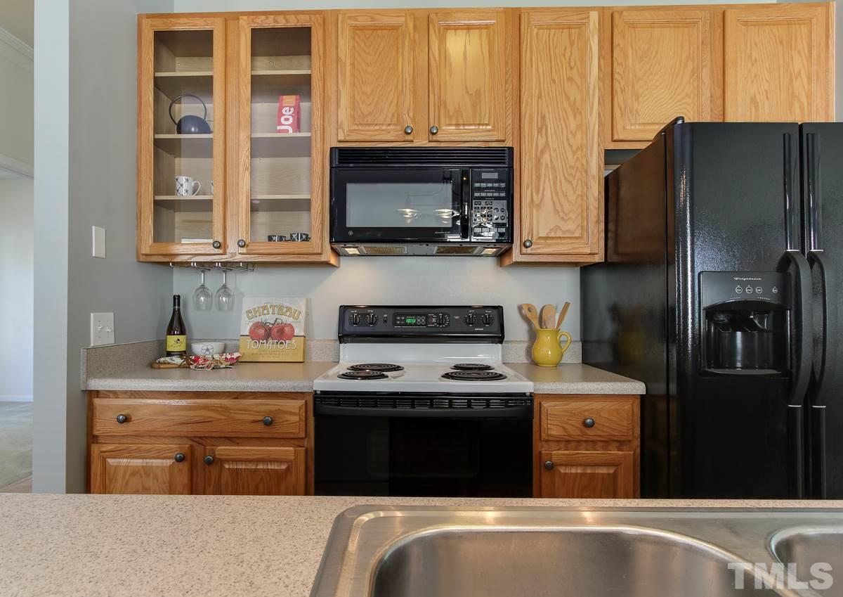 558 East Martin Street Raleigh, NC 27601 - Photo 10 of 24 a kitchen with stainless steel appliances granite countertop a refrigerator stove and sink