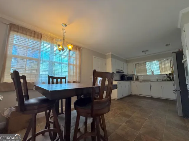 a view of a dining room with furniture and window