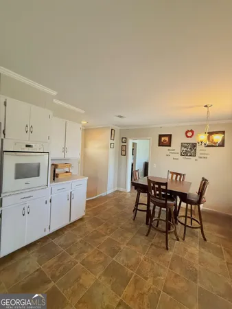 a kitchen with cabinets and wooden floor
