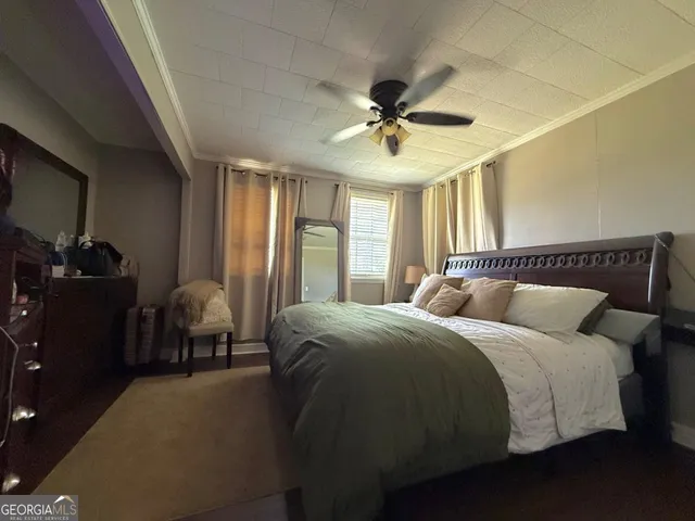 a bedroom with a bed and a mirror