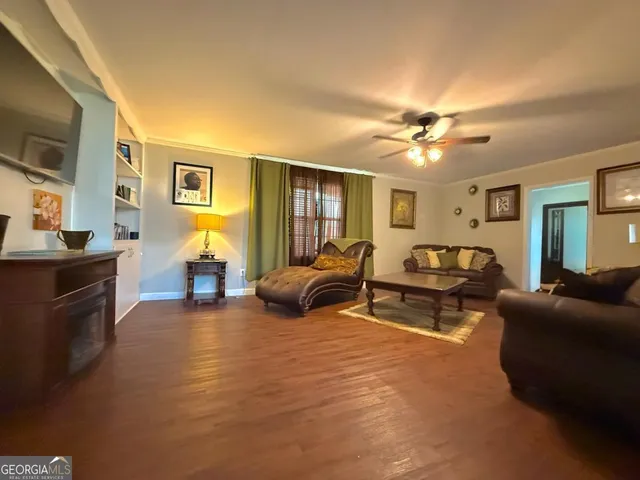 a bedroom with furniture and a ceiling fan