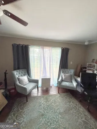 a living room with furniture rug and window