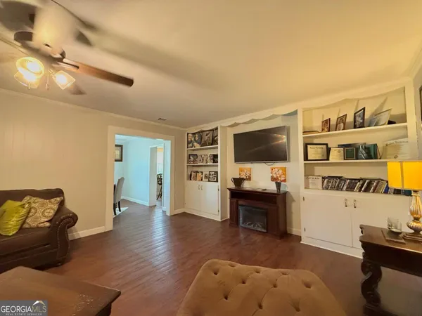 a living room with furniture and a flat screen tv