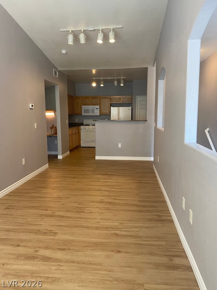 10550 West Alexander Road, Unit 2210 Las Vegas, NV 89129 - Photo 4 of 14 A seamless flow connects the naturally illuminated living area to a practical kitchen space.