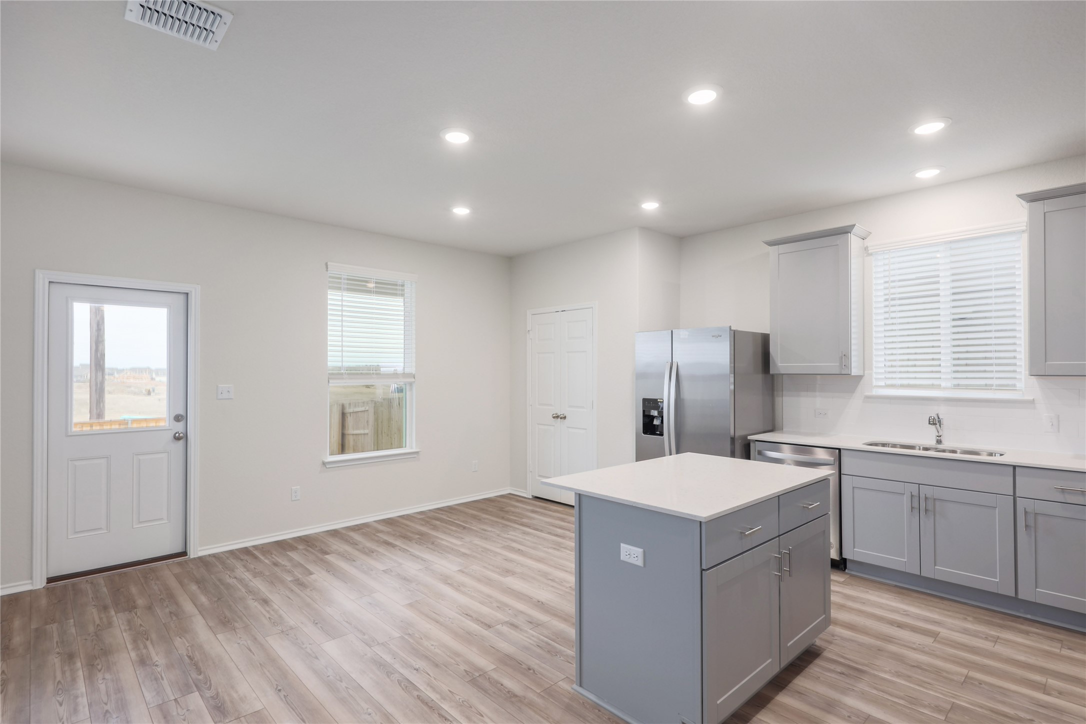 212 Sugar Cane Road Buda, TX 78610 - Photo 12 of 40 a large kitchen with a sink a window and stainless steel appliances