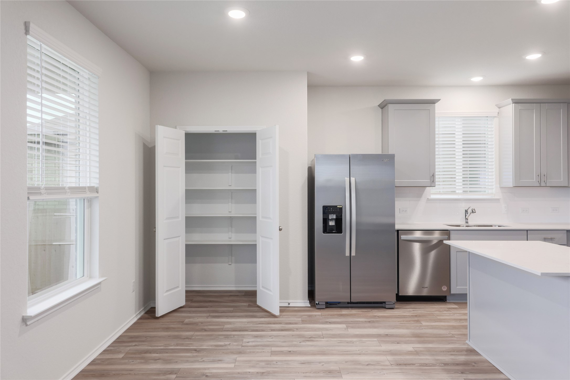 212 Sugar Cane Road Buda, TX 78610 - Photo 13 of 40 a kitchen with stainless steel appliances granite countertop a refrigerator and a sink