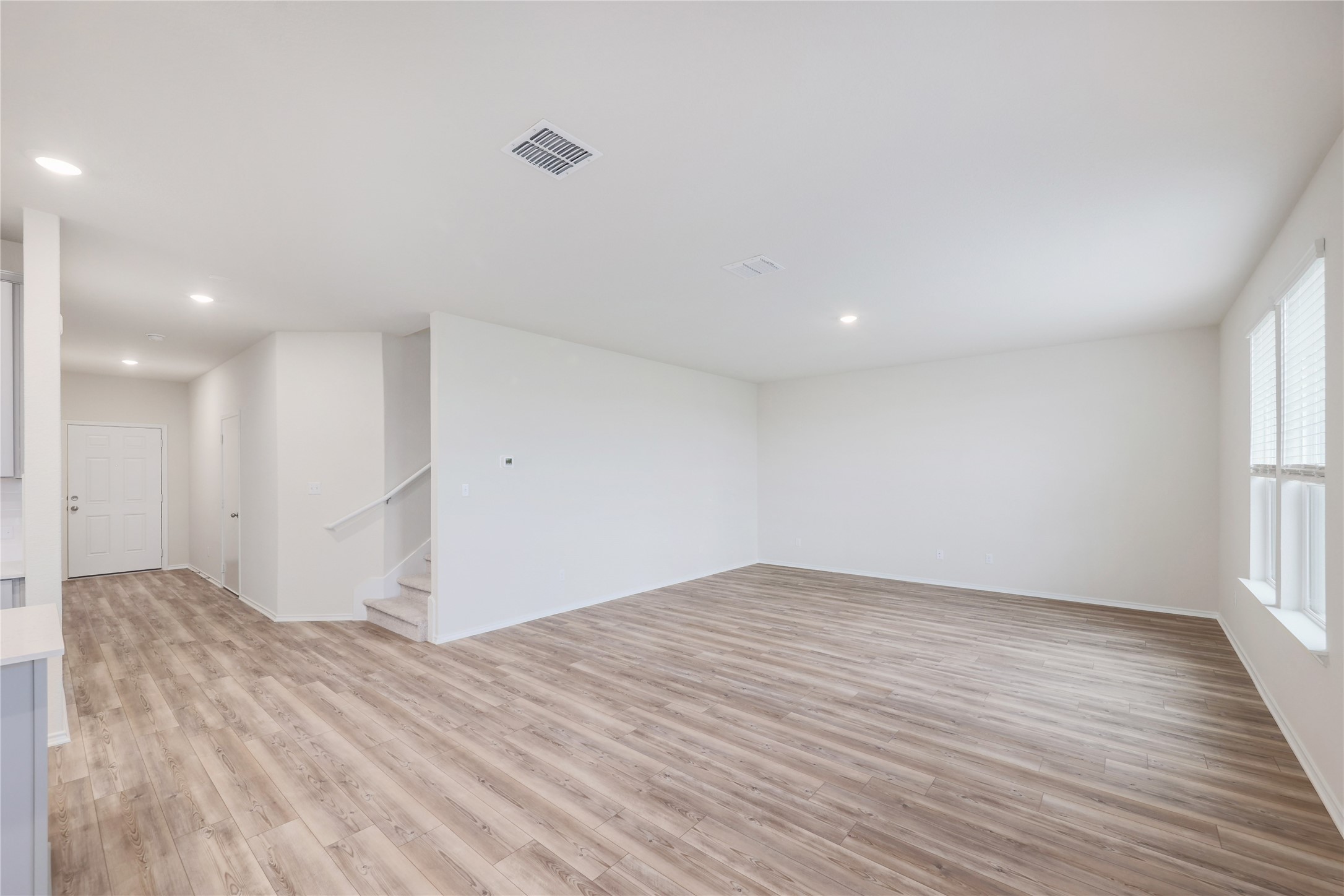 212 Sugar Cane Road Buda, TX 78610 - Photo 5 of 40 a view of empty room with wooden floor