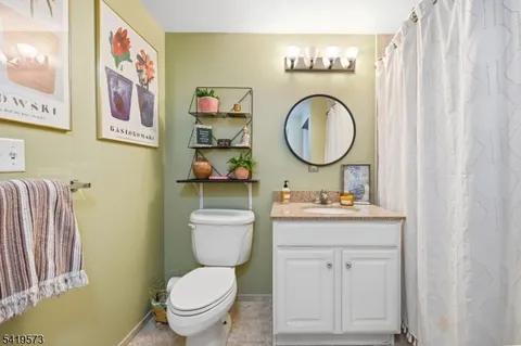 a bathroom with a toilet a sink and a mirror