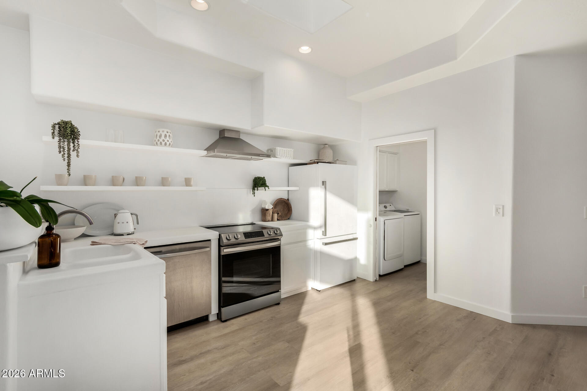 7955 East Chaparral Road, Unit 122 Scottsdale, AZ 85250 - Photo 11 of 29 a kitchen with a stove and a refrigerator
