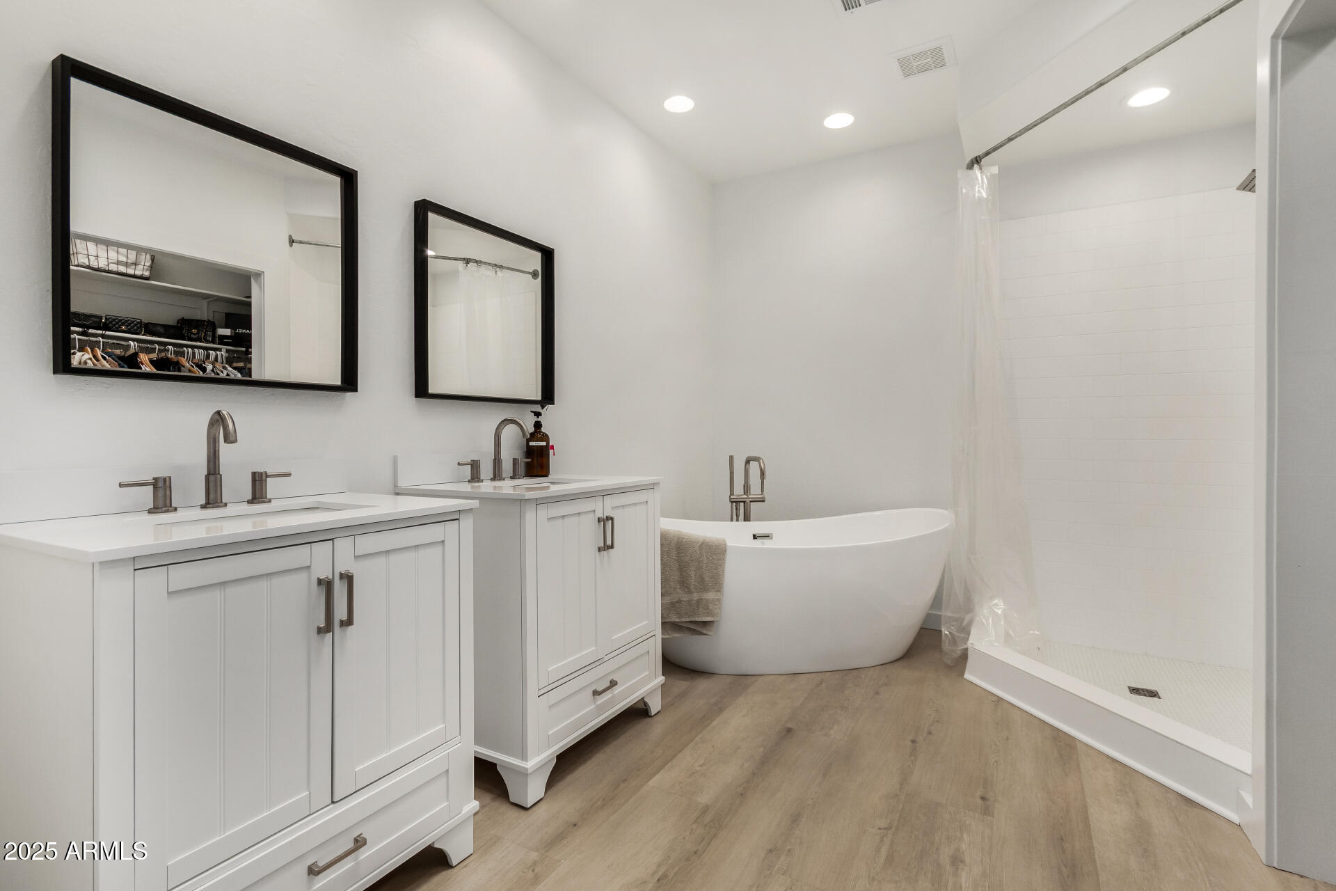 7955 East Chaparral Road, Unit 122 Scottsdale, AZ 85250 - Photo 15 of 29 a bathroom with a double vanity sink mirror and bathtub