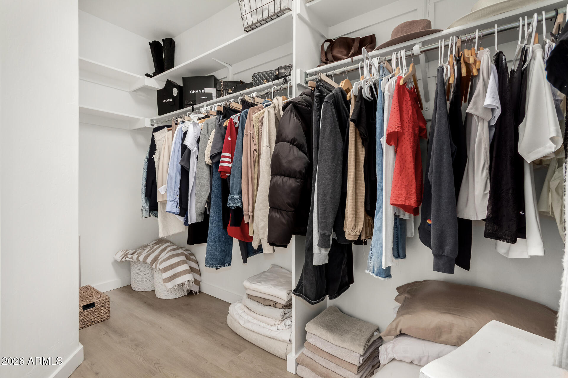 7955 East Chaparral Road, Unit 122 Scottsdale, AZ 85250 - Photo 16 of 29 a view of walk in closet with clothes and shoes