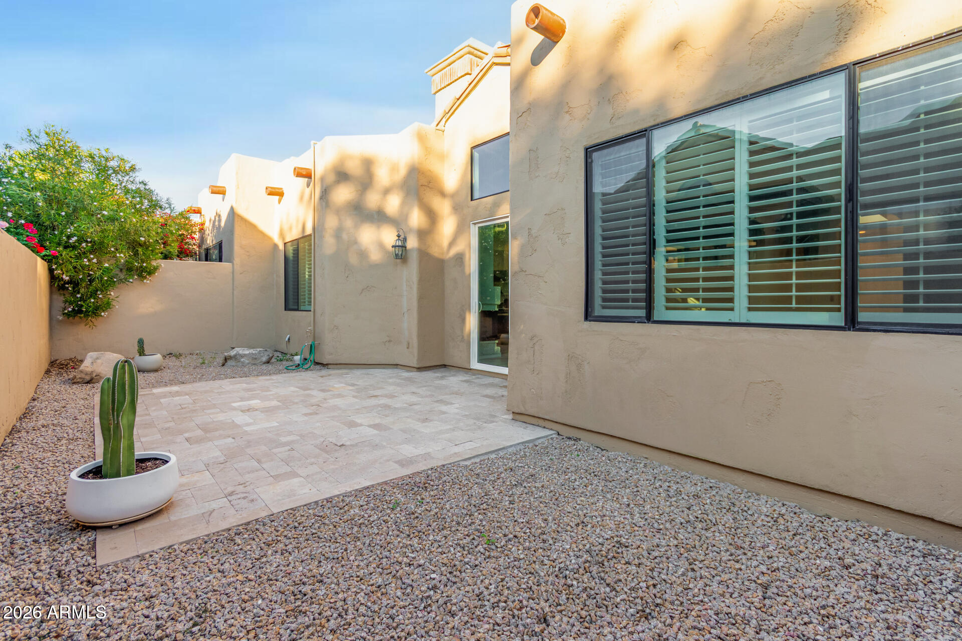 7955 East Chaparral Road, Unit 122 Scottsdale, AZ 85250 - Photo 23 of 29 a view of a house with a potted plant