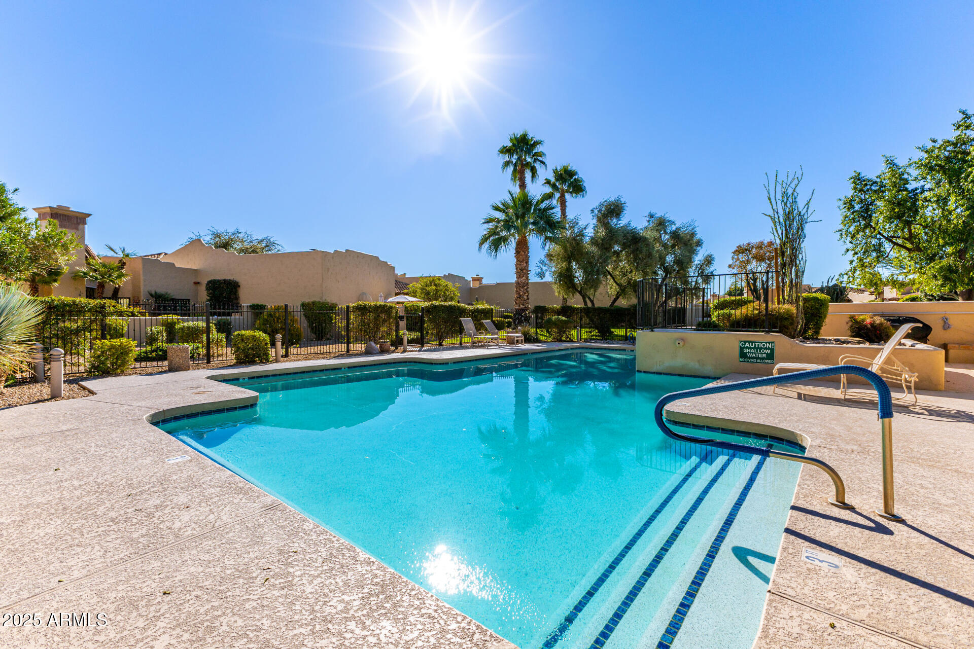 7955 East Chaparral Road, Unit 122 Scottsdale, AZ 85250 - Photo 25 of 29 a view of a swimming pool with a patio and a garden