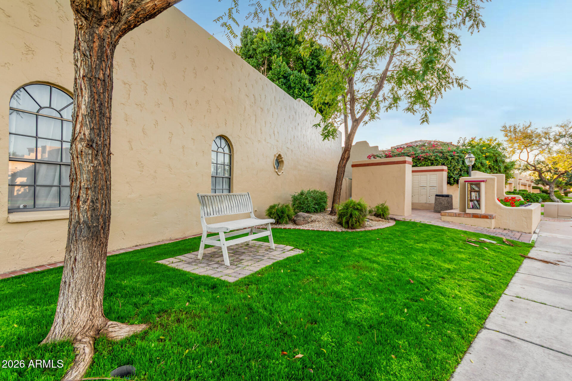 7955 East Chaparral Road, Unit 122 Scottsdale, AZ 85250 - Photo 28 of 29 a front view of a house with a yard