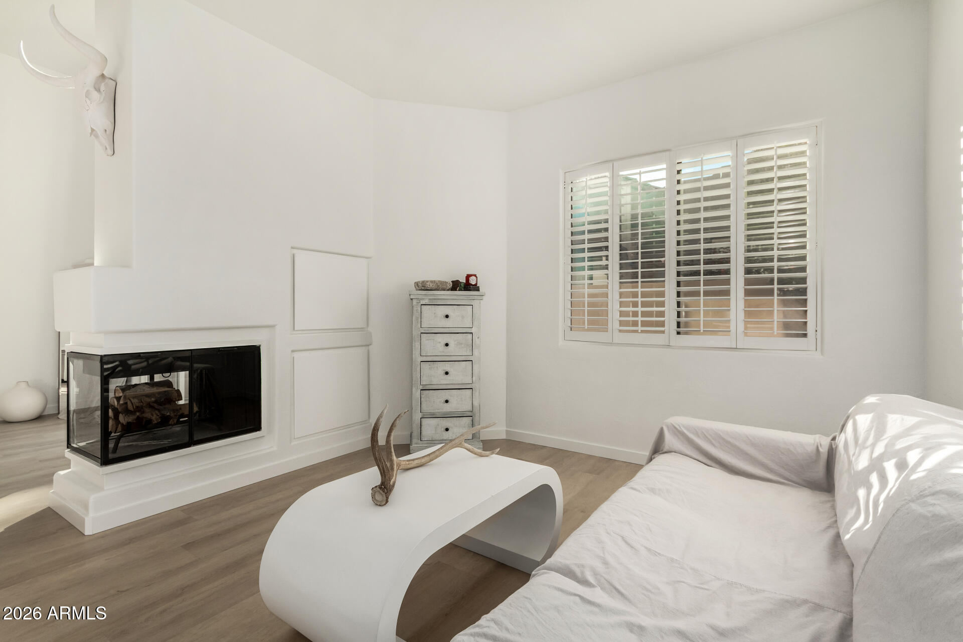 7955 East Chaparral Road, Unit 122 Scottsdale, AZ 85250 - Photo 8 of 29 a bedroom with a bed a fireplace and a large window