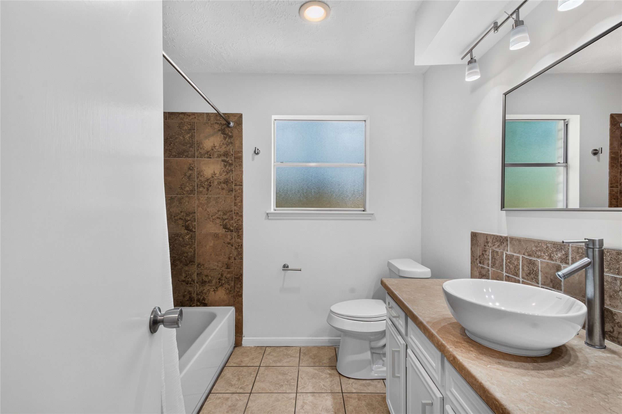 25223 Lynbriar Lane Spring, TX 77373 - Photo 19 of 32 The full secondary bathroom features a tub and shower combination, an updated vessel sink, light and faucets and plenty of counter space.