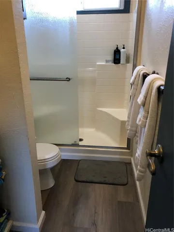 a bathroom with a toilet and a shower