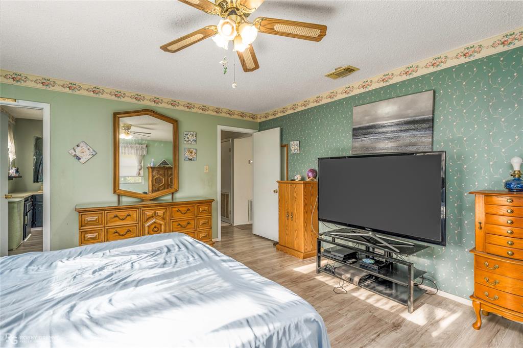 251 Tom Murphy Road Jamestown, LA 71045 - Photo 28 of 40 a bedroom with a bed and a flat screen tv with the dresser