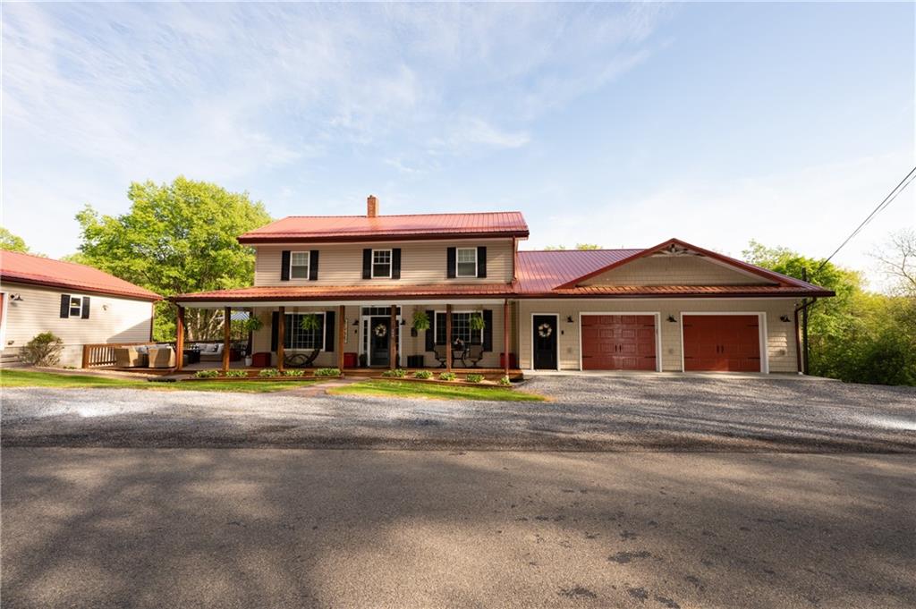 a front view of a house with a yard and trees