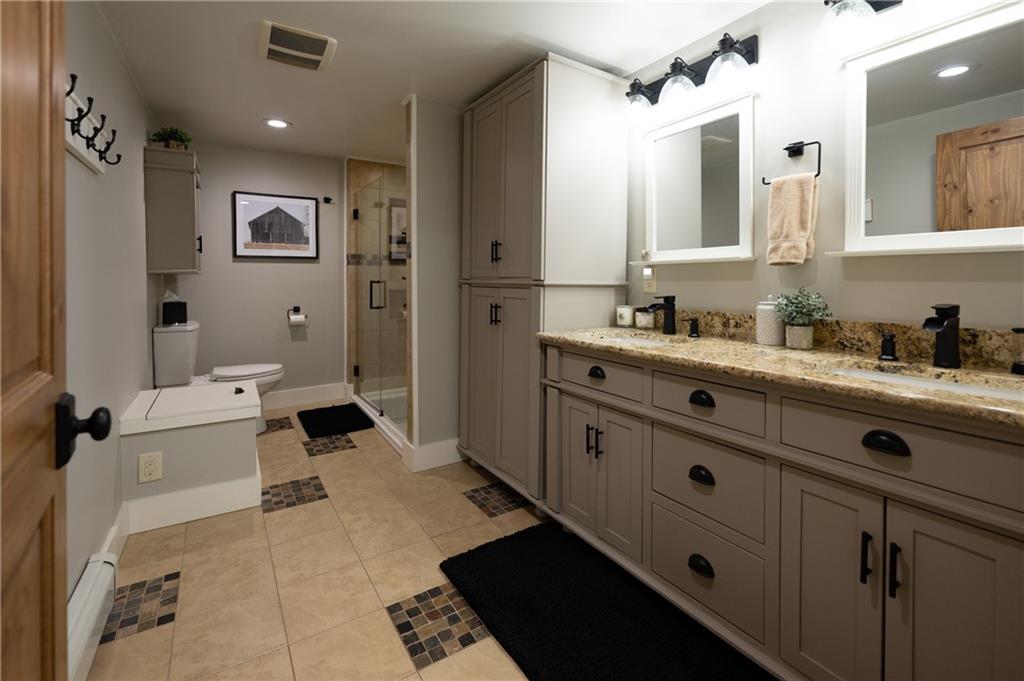 304 Ellermeyer Road Walston, PA 15781 - Photo 18 of 50 a bathroom with a tub sink toilet and mirror